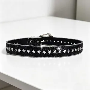 Black glitter star rivet belt detail showing shiny surface and metal star studs design.