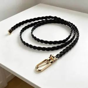Black braided thin belt for women, elegant gold metal buckle, stylish dress accessory detail.