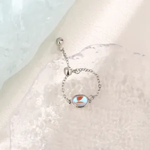 Macro view of an iridescent oval moonstone chain ring with an adjustable slider bead.