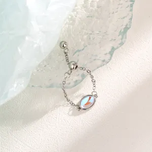 Close-up of the iridescent moonstone and adjustable slider chain on the silver ring.