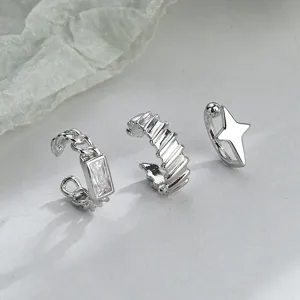 Set of three silver ear cuffs featuring star, chain, and rectangular zirconia designs.