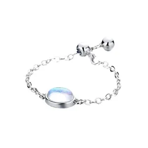 Minimalist adjustable silver chain ring with an iridescent oval moonstone cabochon stone