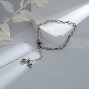 Minimalist silver chain bracelet featuring a letter H square plate and cross charms