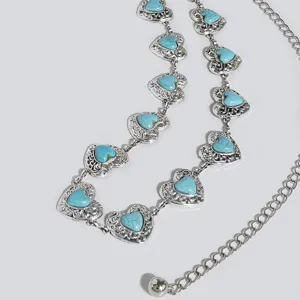 Detailed close-up view of vintage silver-tone waist chain belt with heart turquoise stones