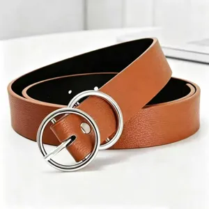 Close up detailed view of women brown PU leather belt featuring silver double ring metal buckle.