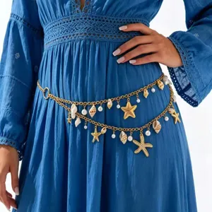 Detail shot of boho gold layered waist chain with starfish shell pearl pendants beach body jewelry