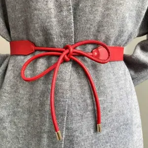 Red leather decorative waist belt detail, elegant tie knot design for women dresses.
