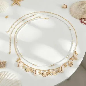 Close-up details of Bohemian multi-layer waist chain with seashells and pearls for beach.