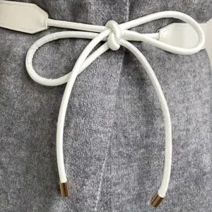 White thin leather belt for women, elegant knotted dress waist accessory for sweater coat.