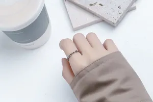 Detail of vintage silver open ring with geometric diamond lattice design on finger