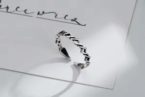 Macro detail of retro Thai silver open ring with geometric zigzag rhombus pattern