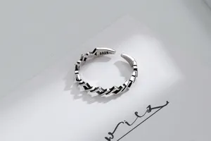 Macro view showing the intricate geometric pattern and S925 stamp on silver ring