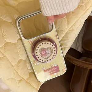 Close-up of teddy bear magnetic phone case in creamy gold with heart stand design.