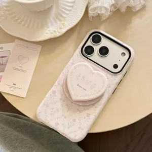 Detailed view of French style pink floral iPhone case featuring a heart-shaped grip