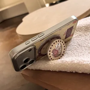 Close-up detail of the cute teddy bear phone case featuring a MagSafe ring and pop stand.