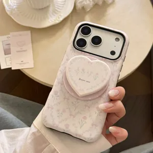 Close-up of French pink floral iPhone case featuring a matching heart-shaped phone grip