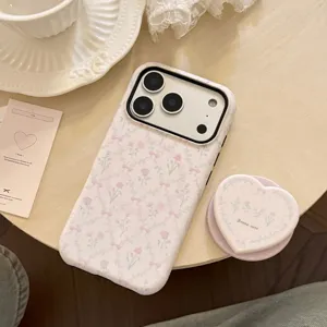 Detailed view of French floral phone case with matching pink heart-shaped phone grip