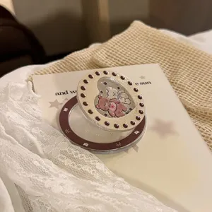 Macro detail of a cute bear glitter phone grip with a vintage cream and brown design