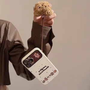 Detailed view of cute bear iPhone case with plush lanyard in beige and brown