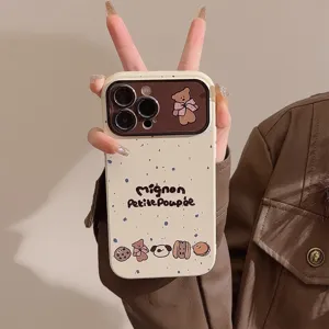 Detailed view of cream iPhone case featuring cute bear and Petite Poupée text