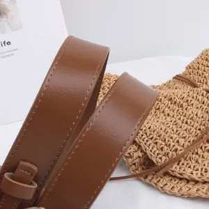 Close-up detail of smooth brown PU leather belt with neat stitching and glossy finish texture.