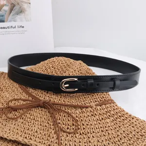 Black PU leather belt detail shot featuring golden pin buckle and texture on straw hat display.