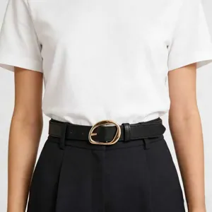 Close-up detail of a vintage black faux leather belt with a golden oval buckle