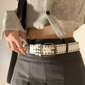 Detailed shot of white faux leather belt with double-row metal rivets and buckle