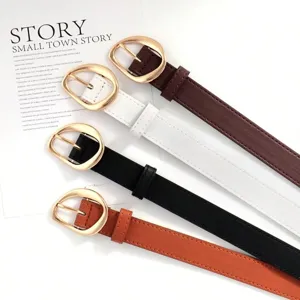 Close-up of vintage women's faux leather belts with gold oval buckles in four colors