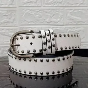Close-up detail of white vintage punk belt with round metal rivets and silver buckle