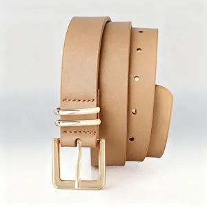 Detail view of a stylish women's retro pin buckle belt in camel with golden hardware.