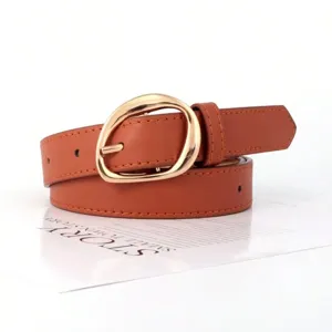 Detailed shot of retro oval gold buckle on a brown faux leather women's belt