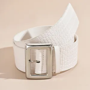 Detailed close-up of a white crocodile textured wide belt with a chunky silver buckle.