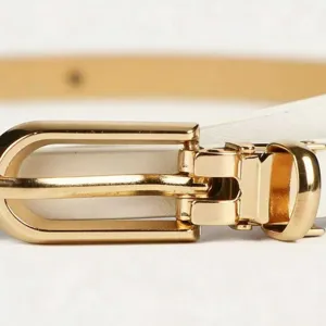 Minimalist women's thin white leather belt detail with gold metal pin buckle for dresses.