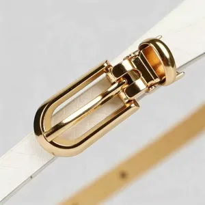 Close-up detail of women thin white leather belt with luxury gold metal pin buckle elegant.