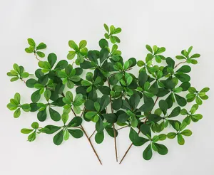 Artificial green plant branches detail, fake banyan leaves foliage for indoor home decoration.