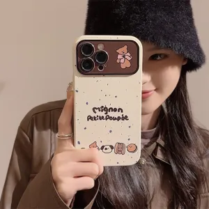 Close-up of a cream iPhone case with cute bear and French text illustrations.