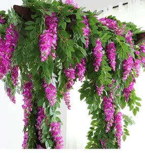 Detailed view of lush purple artificial wisteria flowers hanging from a wooden beam