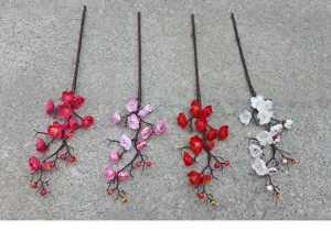 Artificial plum blossom branch detail shot showing realistic floral texture and vibrant colors.