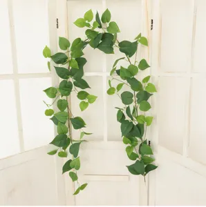 Lush green artificial ivy hanging on a white wooden window frame for stylish home decor.