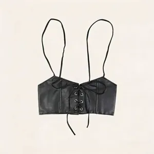 Detailed macro view of black faux leather suspender waist belt with lace-up design
