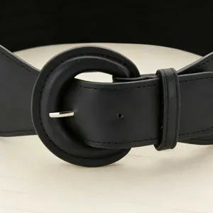 Close-up detail of black wide belt with round leather-covered buckle for dresses