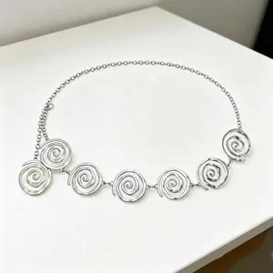 Silver metal waist chain featuring unique spiral circle design, trendy and chic accessory.