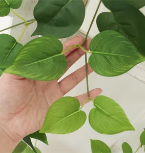 Detailed close-up of artificial green radish vine showing heart-shaped leaf texture