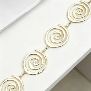 Gold metal waist chain with unique spiral circle links, stylish detail view for fashion outfit.
