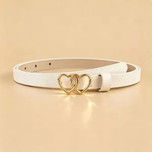 White PU leather belt with interlocking gold double heart metal buckle, elegant detail view.
