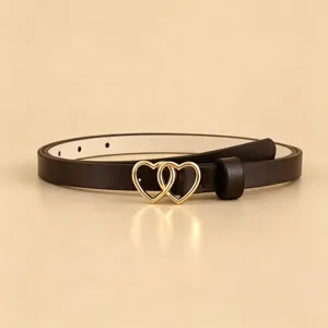 Detailed view of women's black PU leather belt featuring a sleek gold double heart metal buckle.