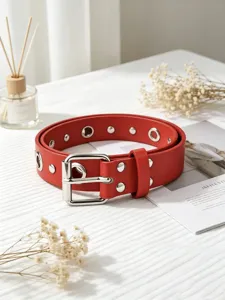 Red punk style women leather belt with double row metal eyelets and pin buckle detail.