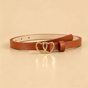 Detailed view of the brown PU leather belt featuring an interlocking gold heart buckle.