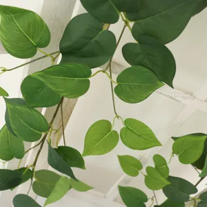 Decorative lush artificial green radish vines hanging on a white wooden lattice fence